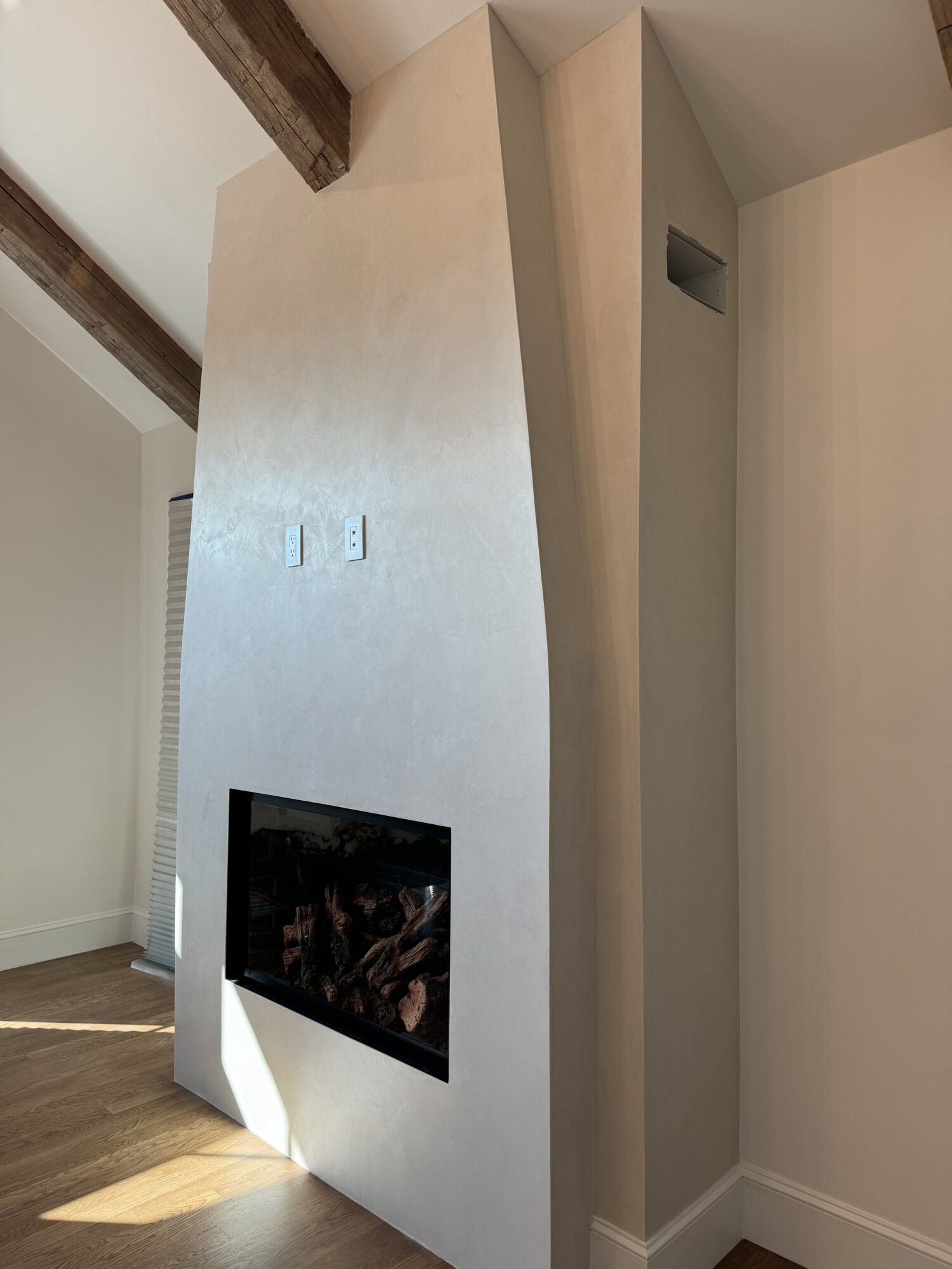 venetian plaster fireplace accent wall in modern room